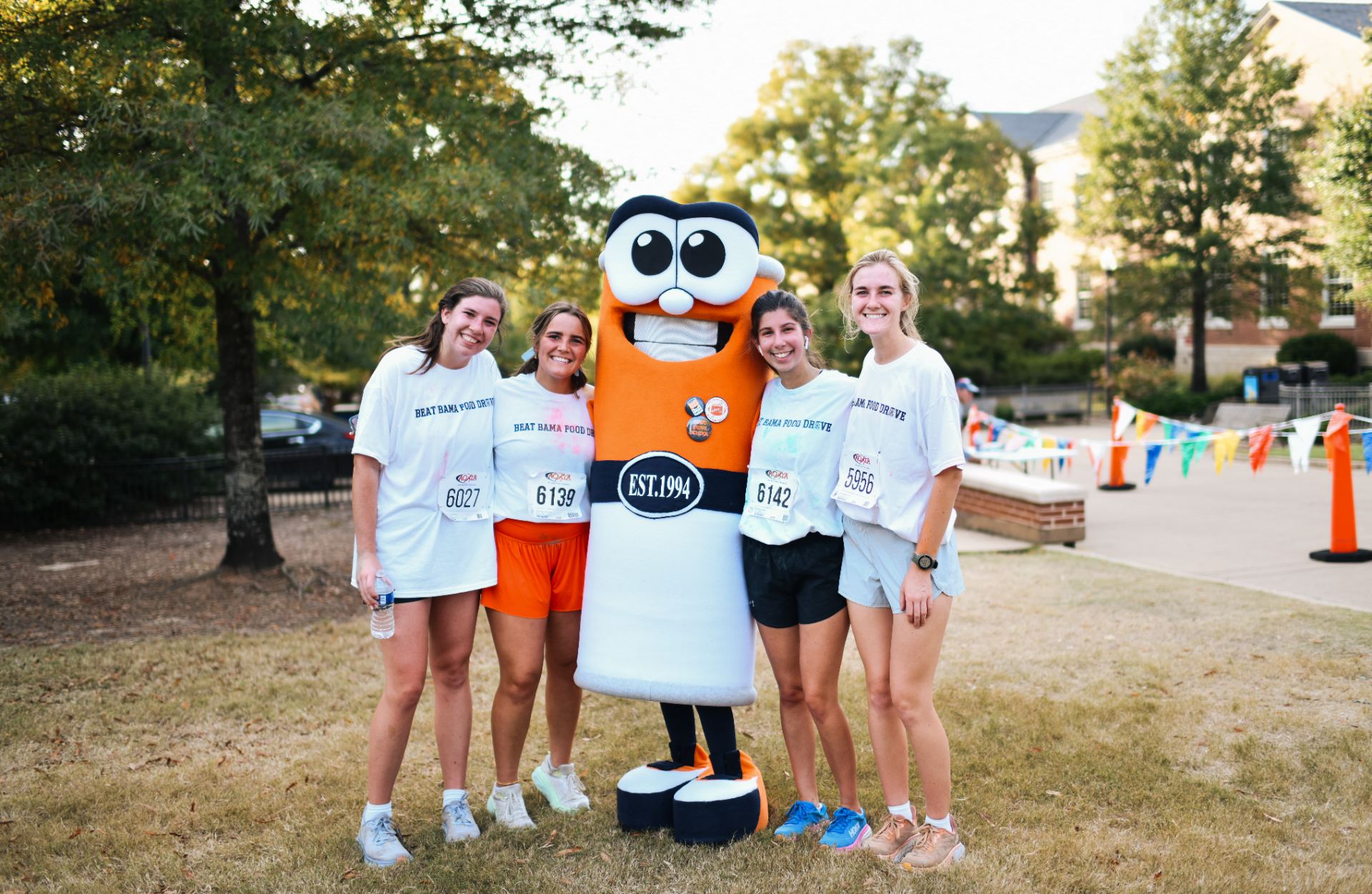 Students pose with the Beat Bama Food Drive Mascot, Canny, at the BBFD 5-K Race